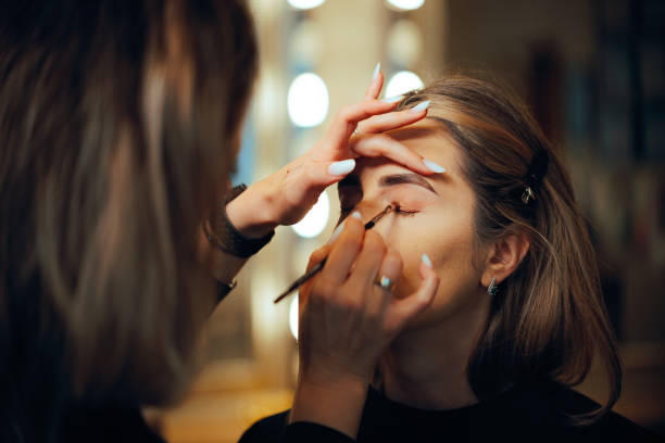 Woman having her looks changed through professional makeup